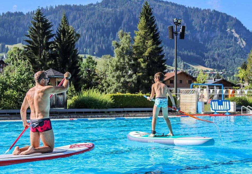 Paddleboarding on the outdoor pool in Megeve